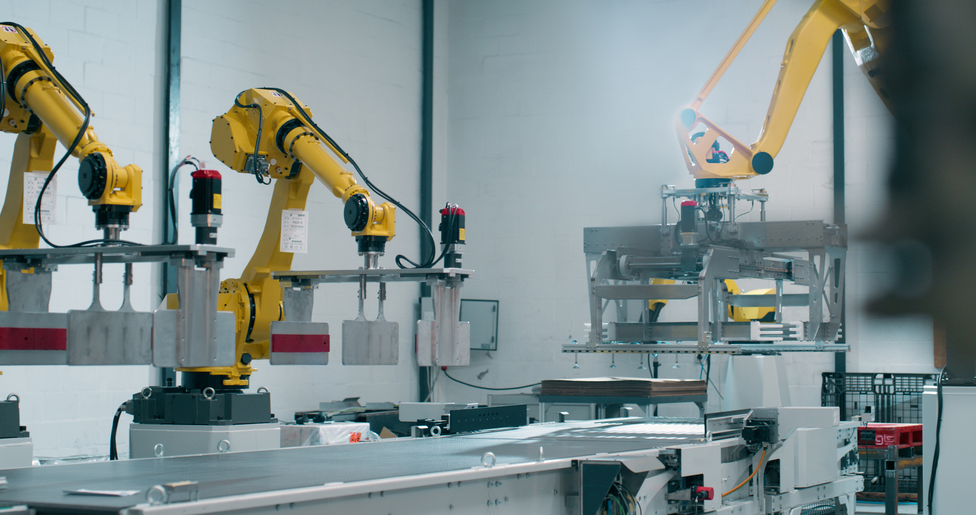 Robotics machines along an automated assembly line in machine shop